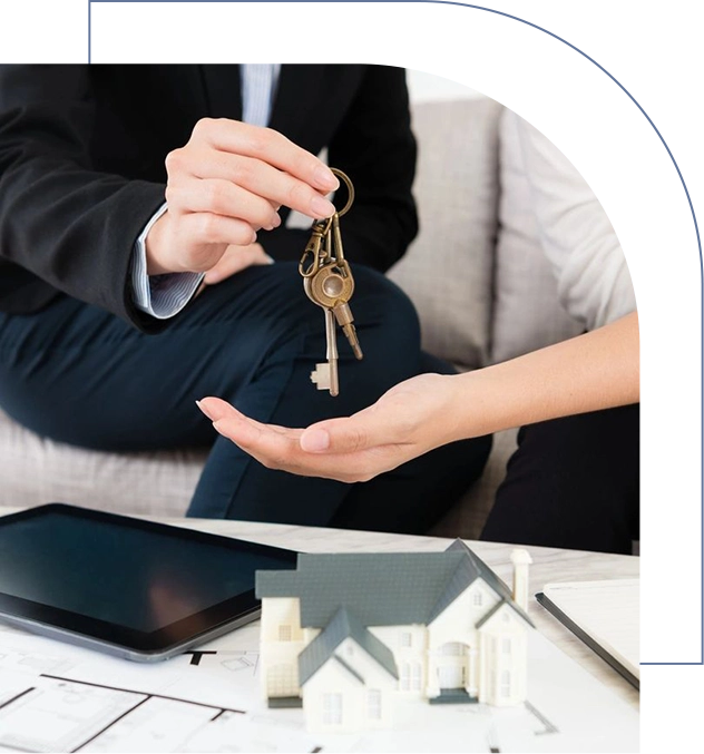 A man and woman exchanging keys to a house.