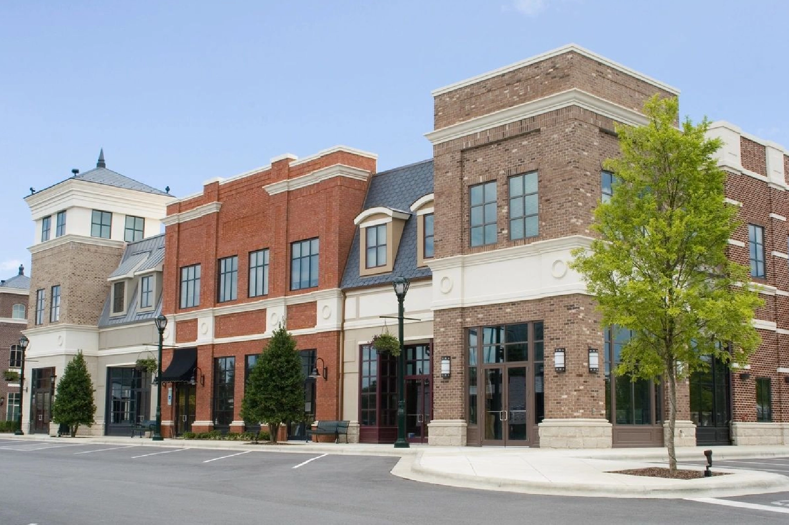 A row of brick buildings on the corner of a street.